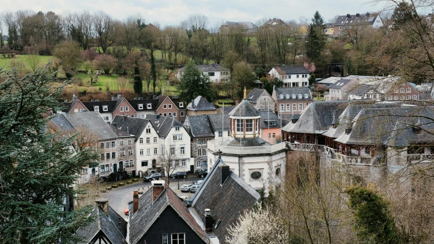 a view of a town from the top of a hill, by Breyten Breytenbach, pexels contest winner, belgium, a quaint, grayish, a cozy