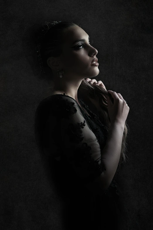 a woman in a black dress standing in the dark, a portrait, inspired by irakli nadar, pexels contest winner, black jewelry, g cgsociety, pondering, back light