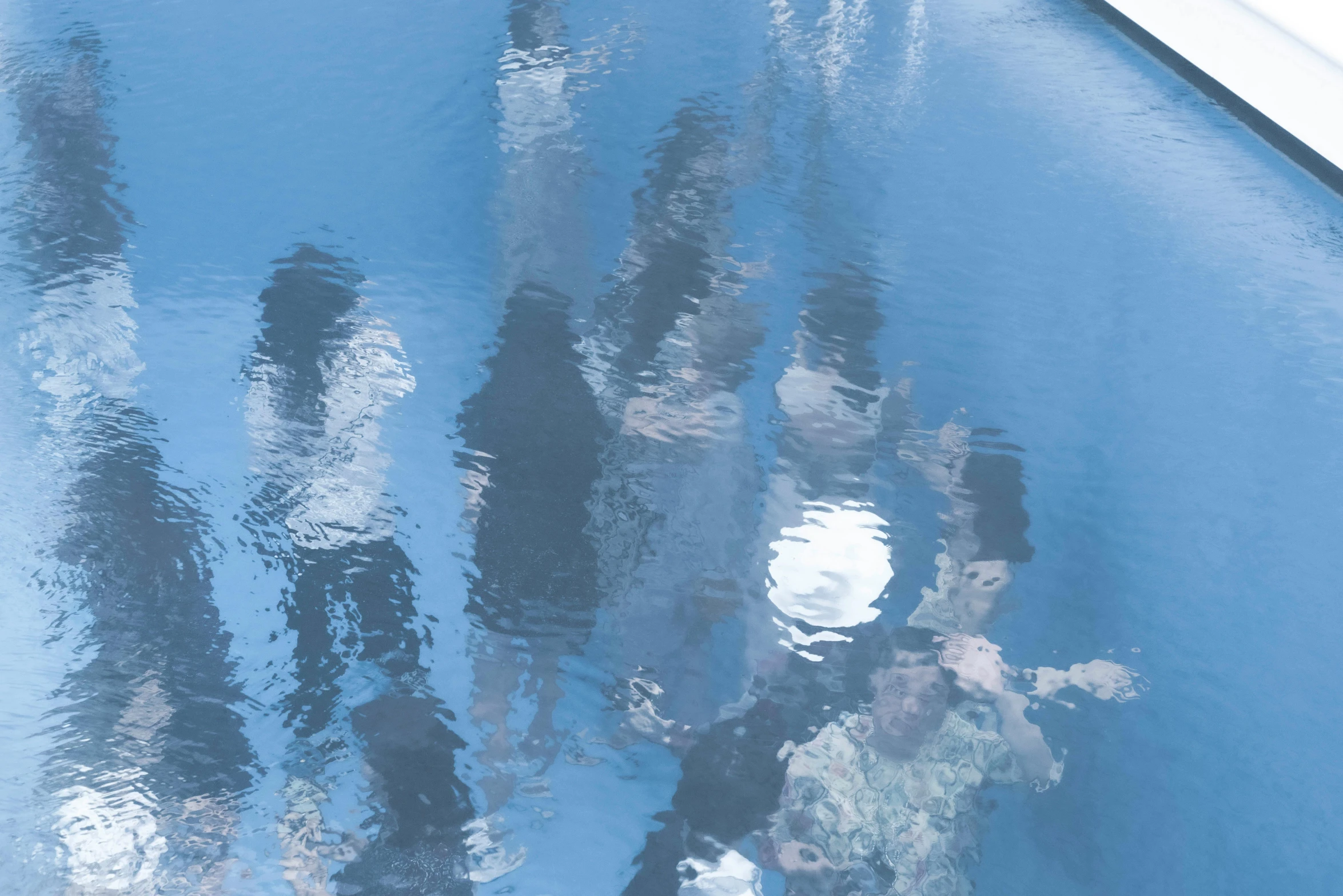 a group of people standing next to a swimming pool, unsplash, impressionism, blue reflections, tokujin yoshioka, close-up from above, detailed photo of virtual world