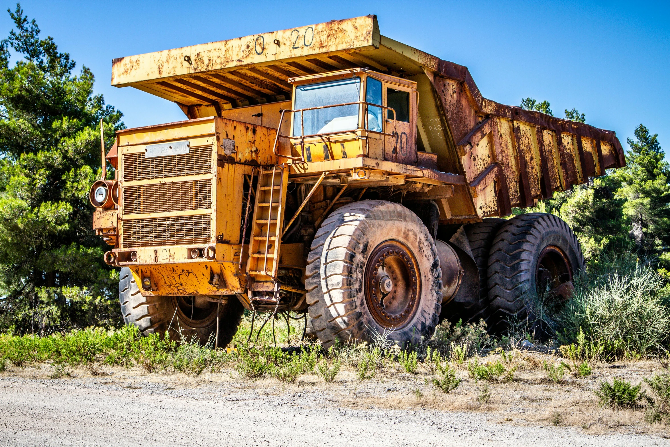 an old dump truck parked on the side of the road, an album cover, by Arnie Swekel, unsplash, auto-destructive art, massive construction machines, avatar image, australian