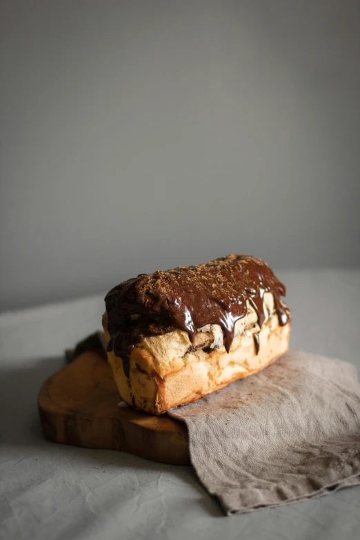 a pastry sitting on top of a wooden cutting board, a portrait, unsplash, photorealism, chocolate. rugged, medium long shot, stuffed, portrait n - 9