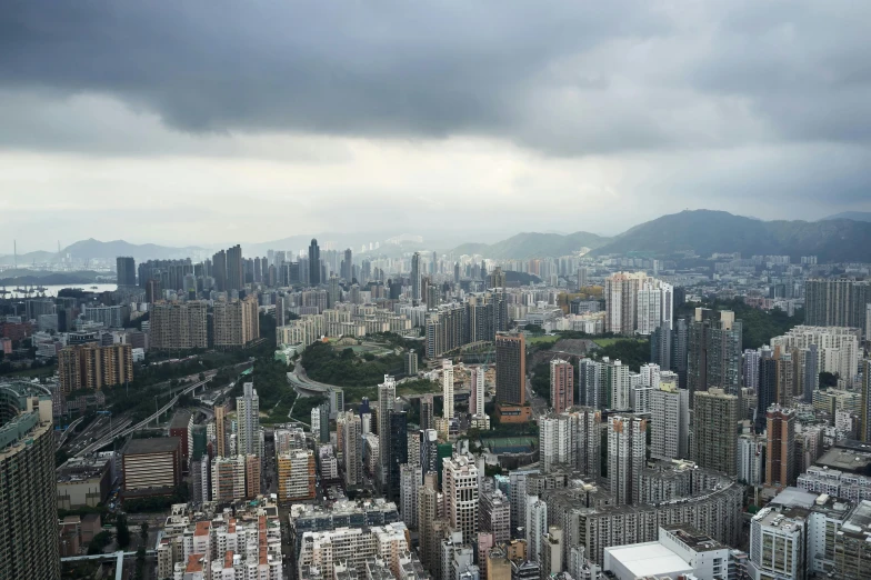 a view of a city from the top of a building, pexels contest winner, hyperrealism, a still of kowloon, grey cloudy skies, 8 k hi - res, multiple stories