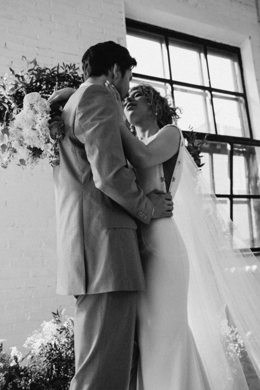 a black and white photo of a bride and groom, by Dan Frazier, unsplash, ffffound, still from a music video, indoor setting, katey truhn