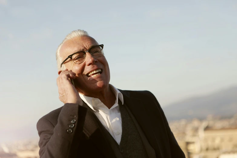 a man in a suit talking on a cell phone, inspired by Heinz Edelman, pexels contest winner, white-haired, sunny sky, ( ( dieter rams ) ), [ cinematic