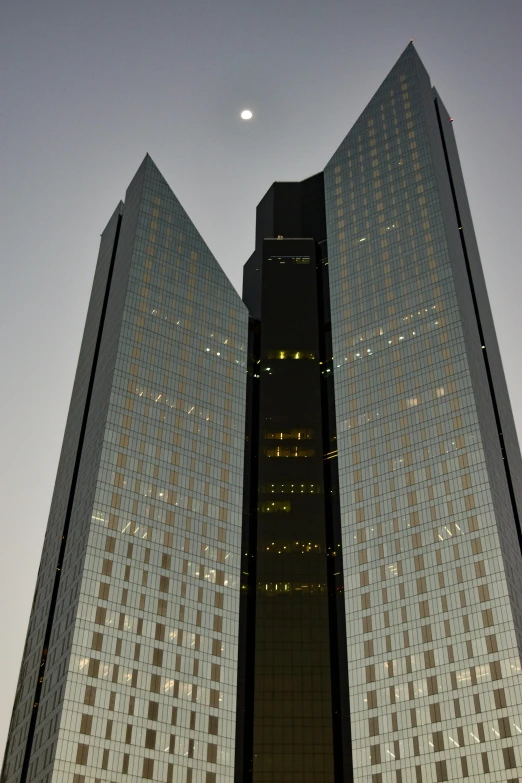 a couple of tall buildings sitting next to each other, inspired by Zaha Hadid, bauhaus, early evening, chile, medium-shot, front lit