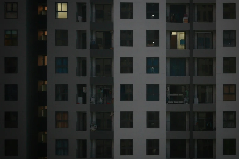 a couple of tall buildings sitting next to each other, a picture, inspired by Andreas Gursky, pexels contest winner, bauhaus, open window at night, soviet apartment building, group of people in a dark room, early morning light