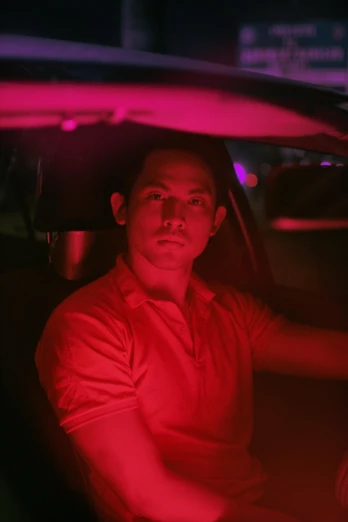 a man sitting in the driver's seat of a car, inspired by Nan Goldin, unsplash, conceptual art, fuschia leds, asian male, ( ( theatrical ) ), shia labeouf