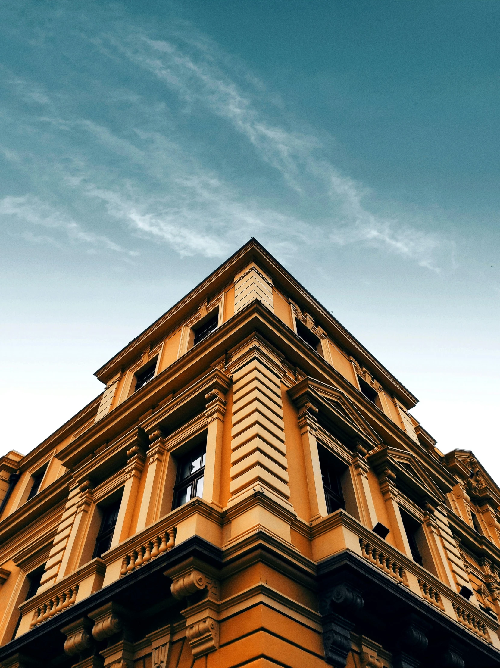 a tall building with a clock on the front of it, pexels contest winner, neoclassicism, ocher, profile image, dramatic angle, high quality image