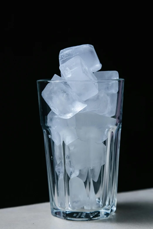 a glass filled with ice sitting on top of a table, cubes, heavily upvoted, ignant, ready to eat