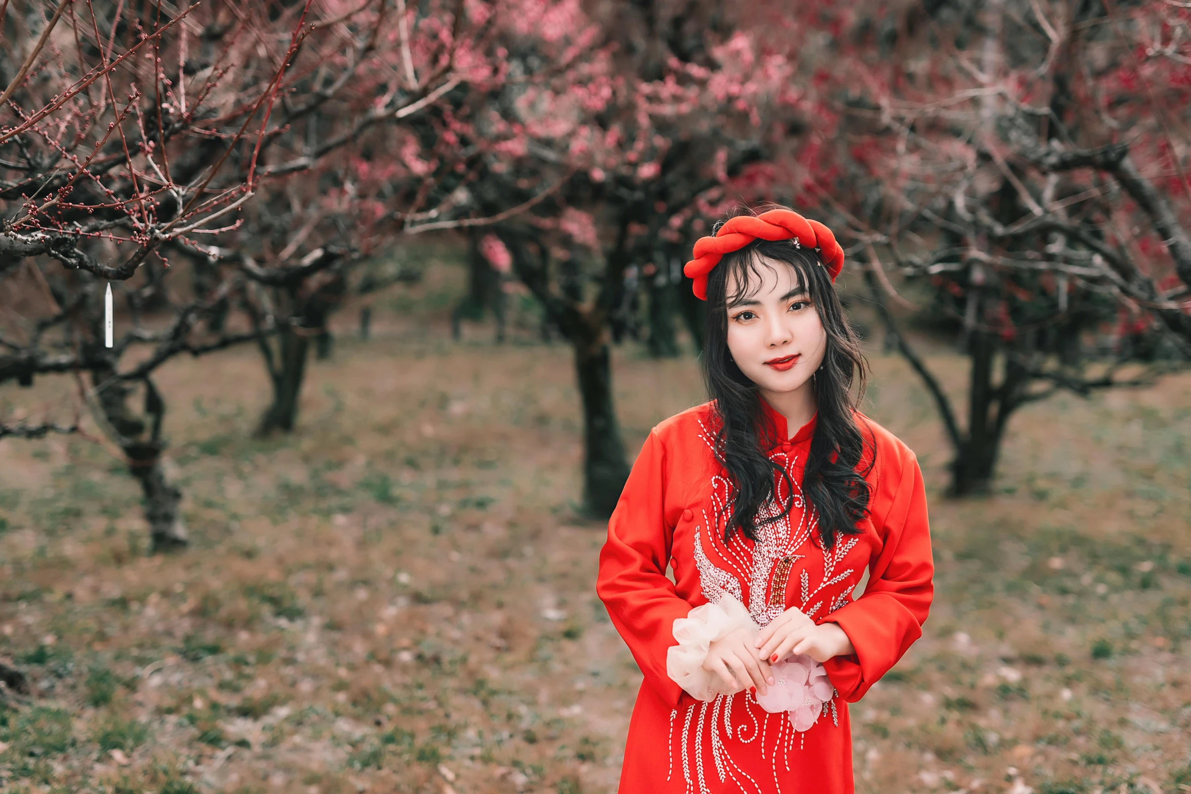 a woman in a red dress standing in a field, pexels contest winner, plum blossom, wearing red attire, pretty face sharp chine, ethnicity : japanese