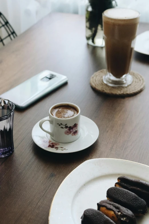 a table with a plate of cookies and a cup of coffee, trending on pexels, hyperrealism, smartphone photo, islamic, gif, unblur