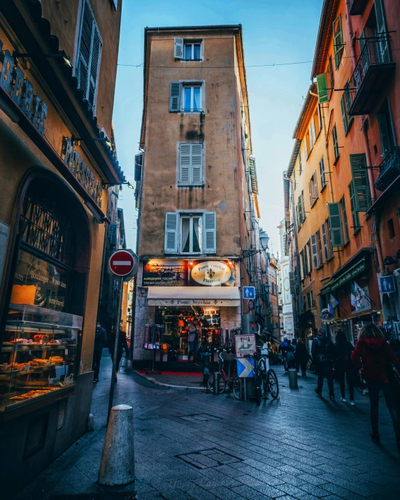 a group of people walking down a street next to tall buildings, a photo, pexels contest winner, renaissance, inside a french cafe, nice, dingy city street, 🦩🪐🐞👩🏻🦳