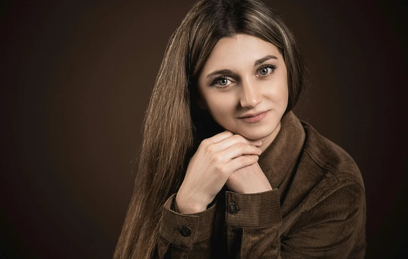 a woman with long brown hair posing for a picture, a character portrait, by irakli nadar, hurufiyya, wearing a brown leather coat, professional portrait hd, ((portrait)), brown:-2