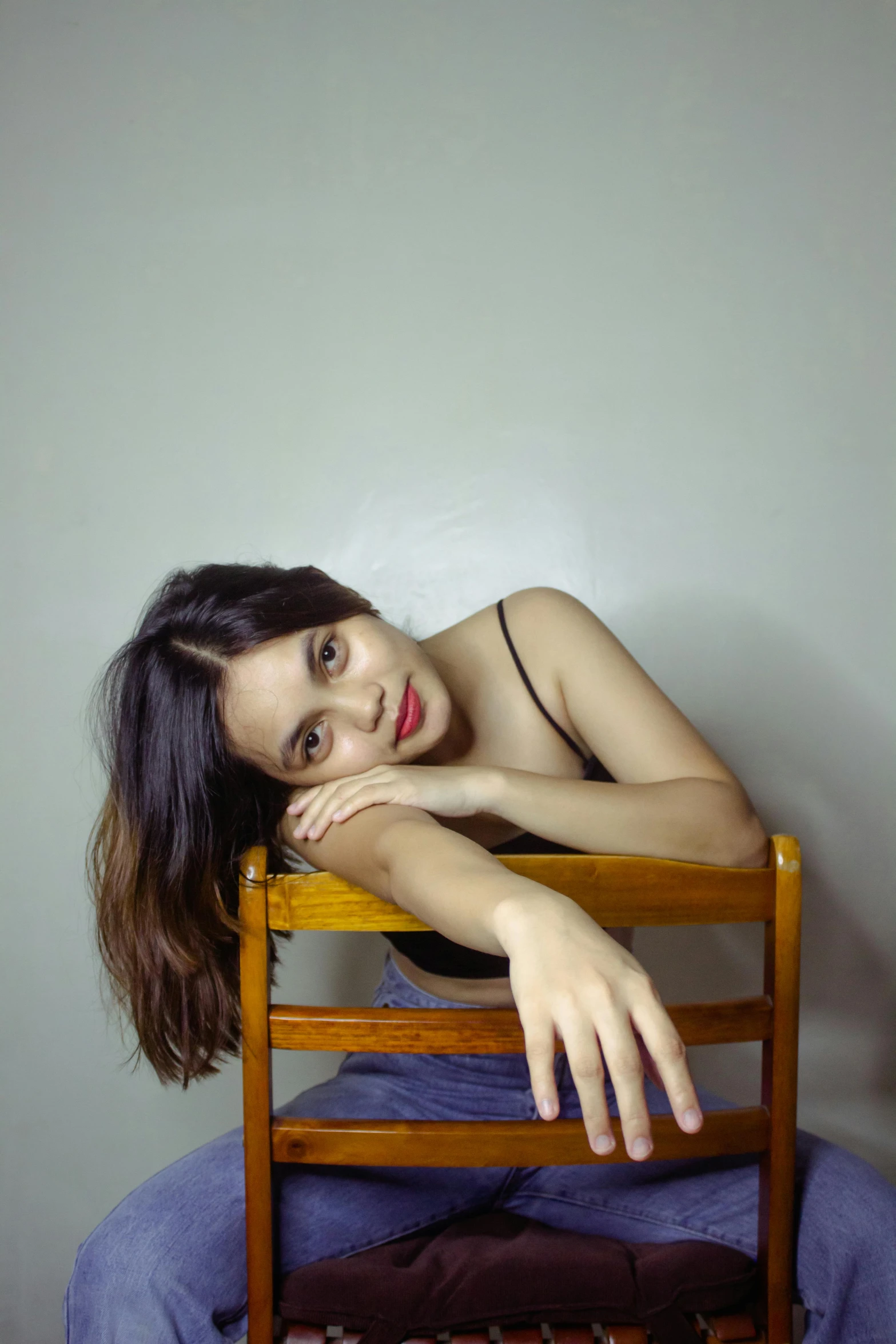 a woman sitting on top of a wooden chair, inspired by Juan Luna, pexels contest winner, halfbody headshot, 🤤 girl portrait, a cute young woman, portrait of ((mischievous))