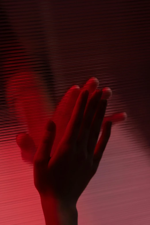 a close up of a person's hand with a red light in the background, pexels contest winner, holography, doing a prayer, horror wallpaper aesthetic, cai xukun, white stripes all over its body
