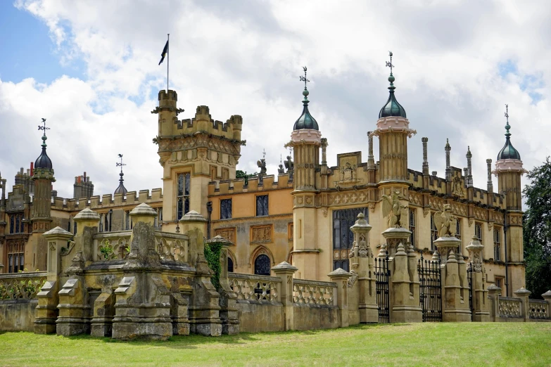 a large castle sitting on top of a lush green field, an album cover, inspired by William Mustart Lockhart, pexels contest winner, renaissance, ornate gold, black domes and spires, exterior botanical garden, madgwick