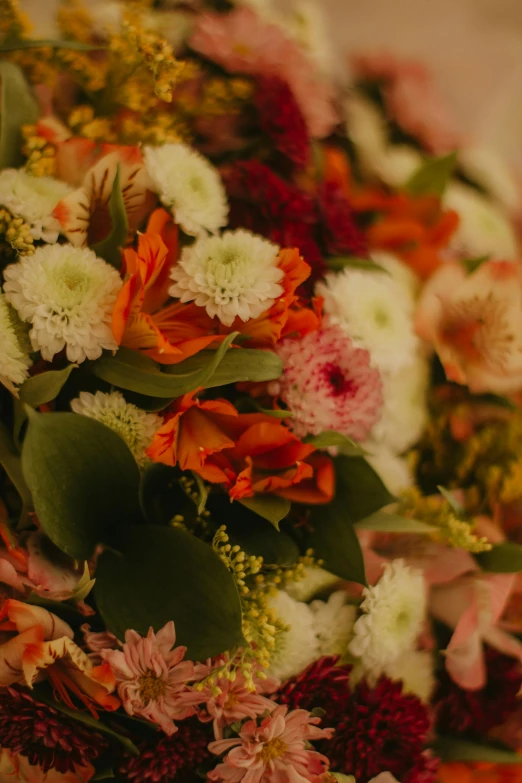 a bouquet of flowers sitting on top of a table, abundant detail, upclose, pink orange flowers, zoomed in