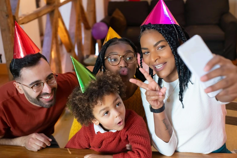 a family taking a selfie at a birthday party, pexels, figuration libre, pointy hat, aida muluneh, coloured, a wooden