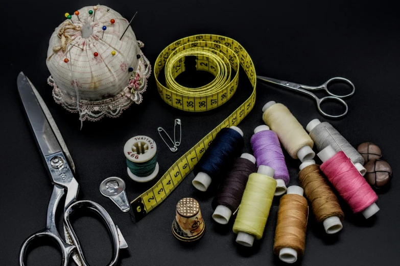 a bunch of spools of thread and a pair of scissors, a cross stitch, by Alejandro Obregón, pexels contest winner, dark garments, 9 9 designs, a small, patchwork