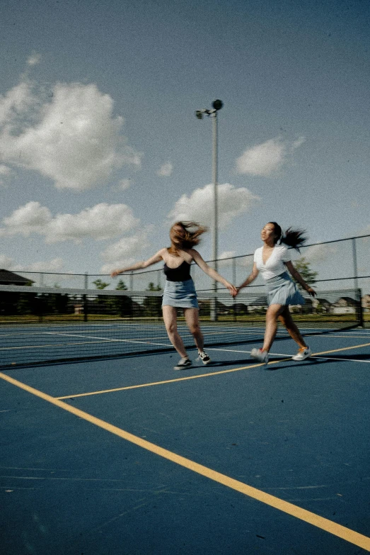 a couple of women standing on top of a tennis court, an album cover, unsplash, feng zhu |, running freely, high school, low iso