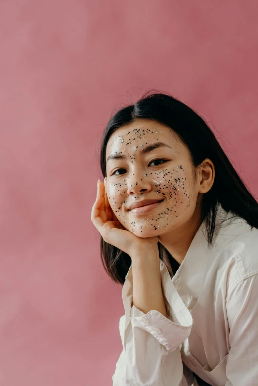 a woman with black spots on her face, trending on pexels, mingei, looking happy, malaysian, product shot, glittery