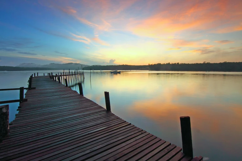 a dock that is next to a body of water, inspired by Edwin Deakin, pexels contest winner, hurufiyya, pastel colored sunrise, tourist destination, humid evening, scenic view