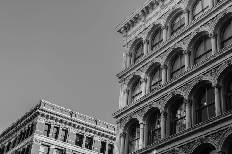 a black and white photo of a tall building, by Adam Rex, pexels contest winner, baroque, new york buildings, soft colors mono chromatic, detailed photograph high quality, tall arches