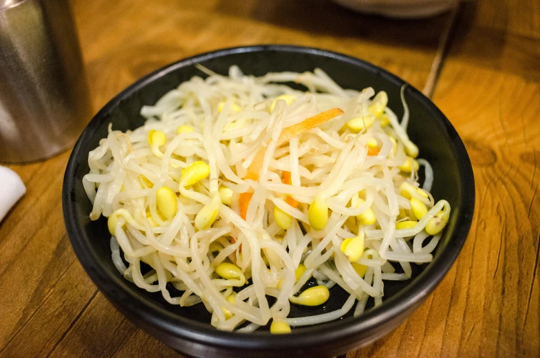 a close up of a bowl of food on a table, a picture, by Sengai, unsplash, mingei, sprouting, 千 葉 雄 大, chiffon, 2 0 0 0's photo
