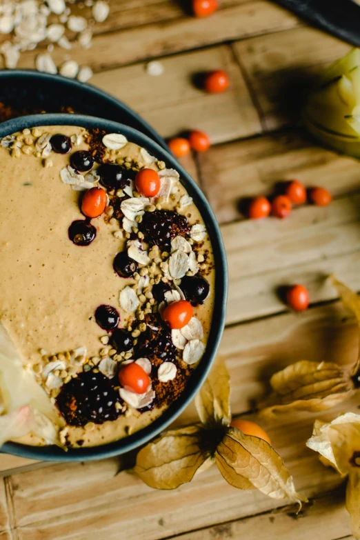 a bowl of oatmeal sitting on top of a wooden table, vanilla smoothie explosion, autumnal, profile image, thumbnail