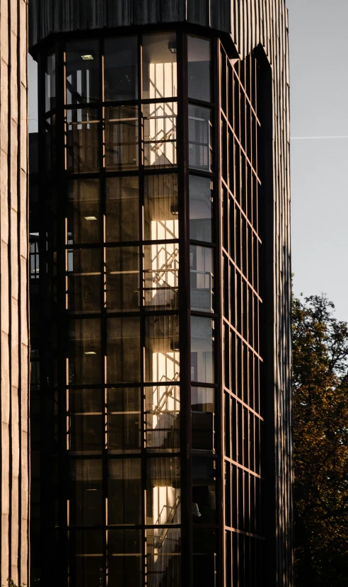 a clock that is on the side of a building, inspired by Richard Wilson, modernism, golden hour photograph, archviz, two towers, steel window mullions