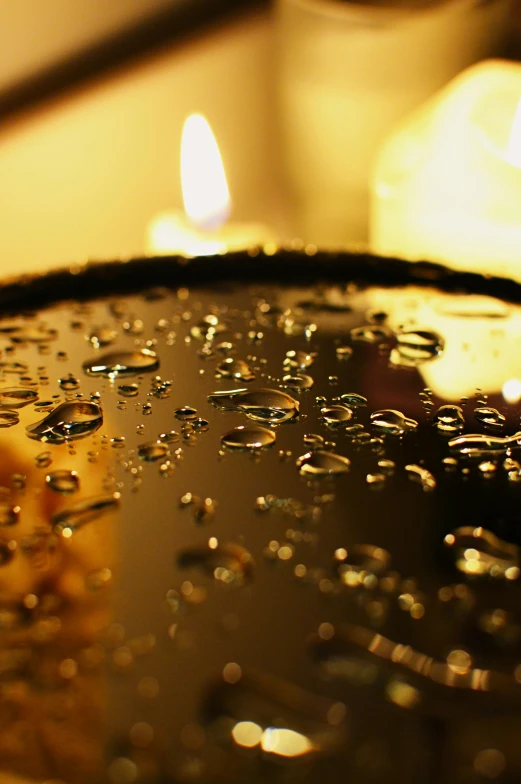 a close up of a plate of food on a table, an album cover, flickr, romanticism, water droplets on lens, candlelight, high quality photo, thirst