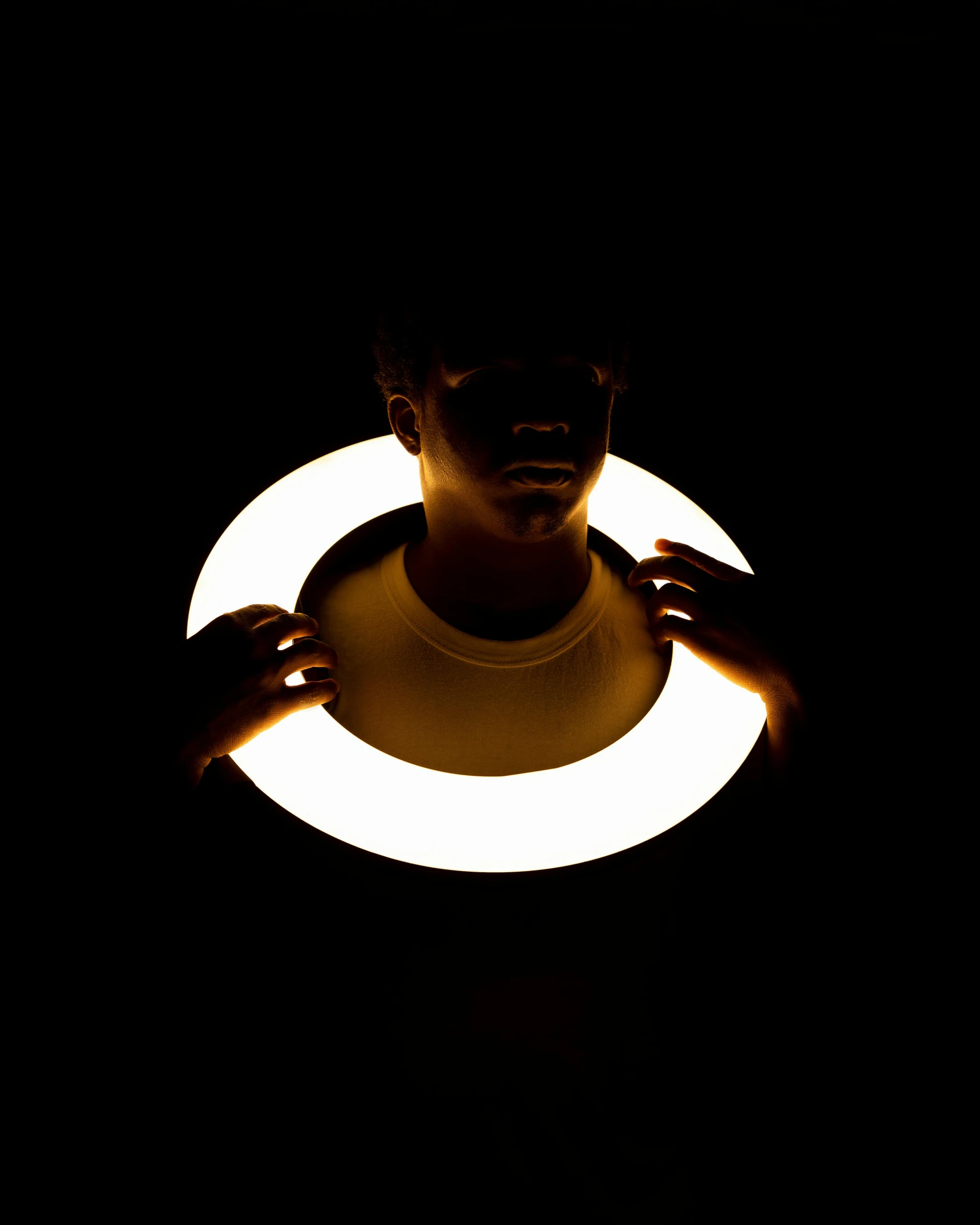 a close up of a person holding a frisbee in the dark, inspired by Jan Rustem, light and space, singularity sculpted �ー etsy, creative lighting, ignant, solar punk product photo