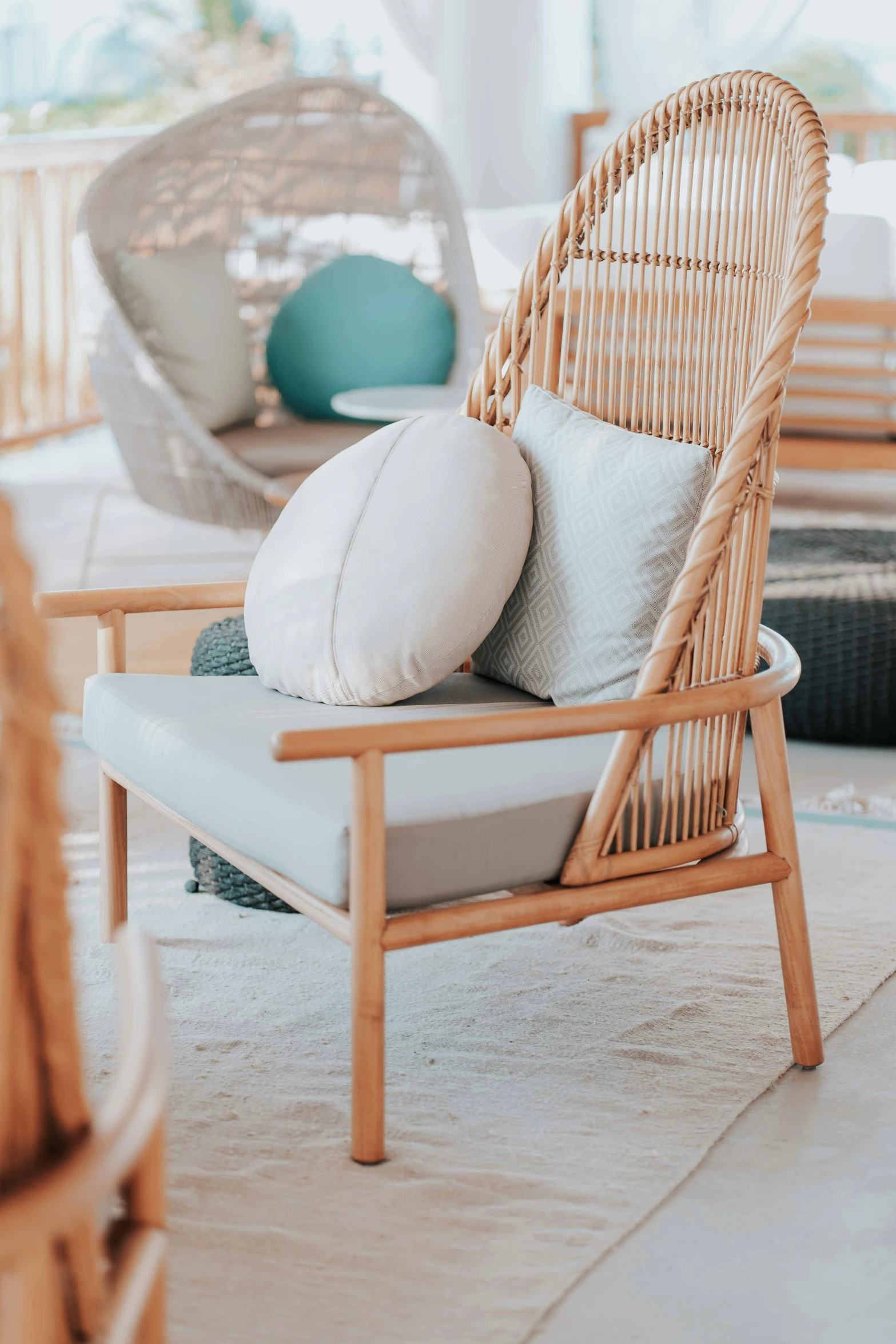 a wicker chair sitting on top of a white floor, on a wooden table