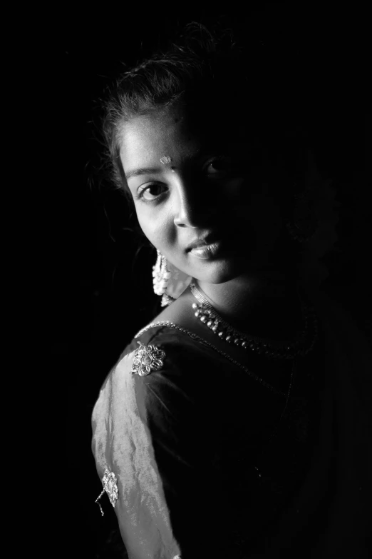a black and white photo of a woman in a sari, a black and white photo, by Sudip Roy, 1 6 years old, ((portrait)), low key lights, young girl