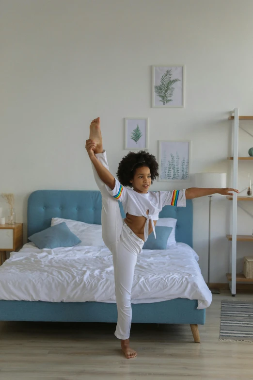 a little girl doing a yoga pose on a bed, pexels contest winner, arabesque, ashteroth, standing upright, gif, cool white