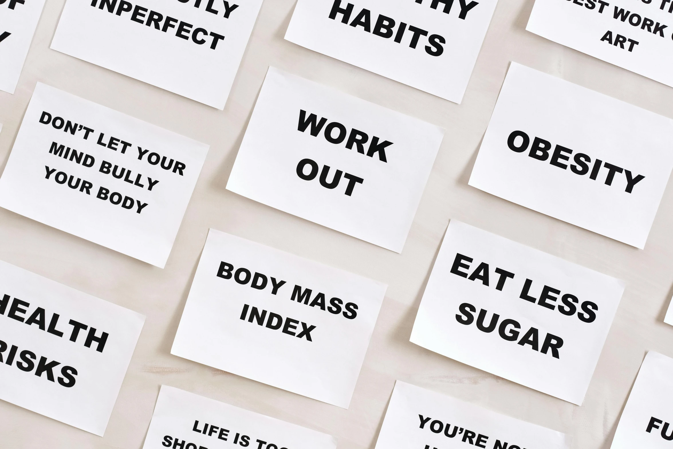 a bunch of stickers that are on a wall, trending on pexels, folds of belly flab, {perfect body}, placards, light academia aesthetic