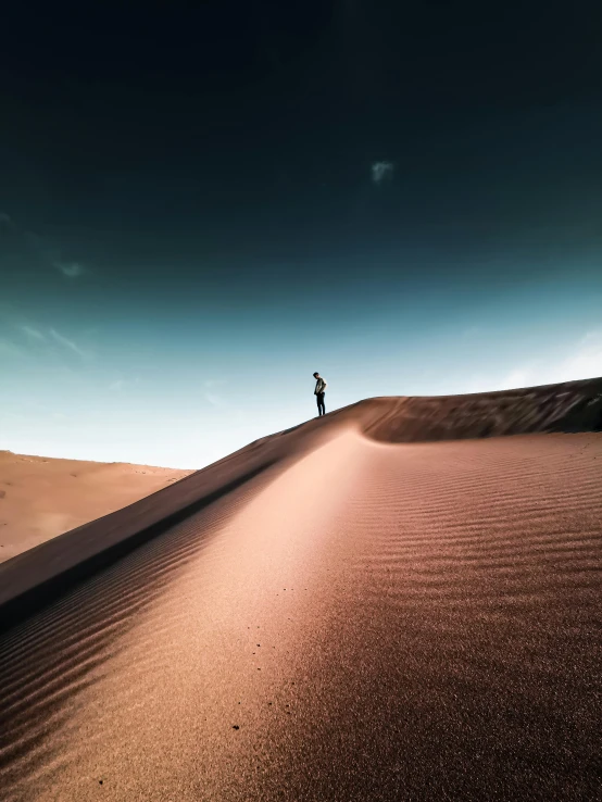 a person standing on top of a sand dune, quixel megascans, today's featured photography 4k, dramatic”