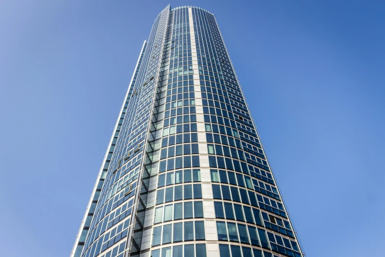 a very tall building with a lot of windows, inspired by Richard Wilson, unsplash, clear blue skies, glass and metal : : peugot onyx, exterior wide shot, profile image