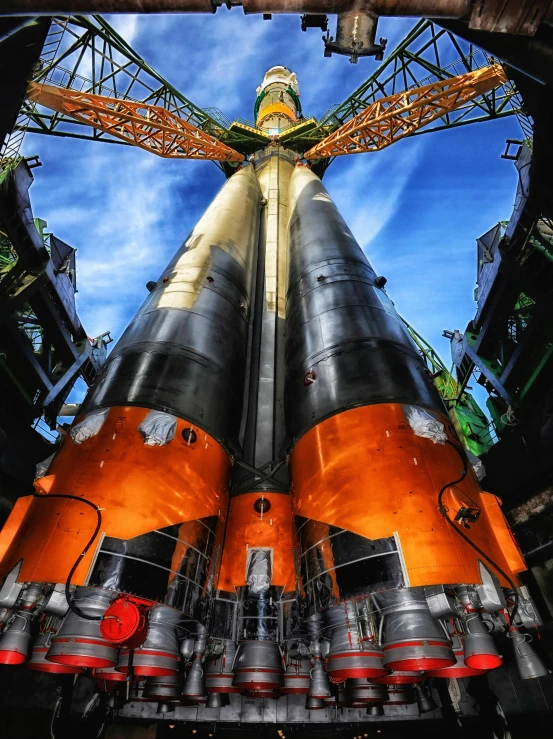 an orange and black rocket sitting inside of a building, inspired by Aleksandr Gerasimov, pexels contest winner, nuclear art, highly detailed hdr, extreme panoramic, cargo spaceships, giant towering pillars