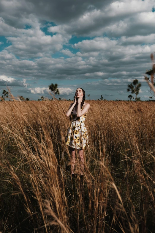 a woman standing in a field of tall grass, by Carey Morris, pexels contest winner, music, standing in the savannah, young woman in a dress, isolated