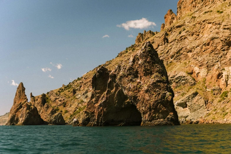 a large rock formation in the middle of a body of water, by Simon Marmion, pexels contest winner, les nabis, black sea, devils horns, slide show, thumbnail