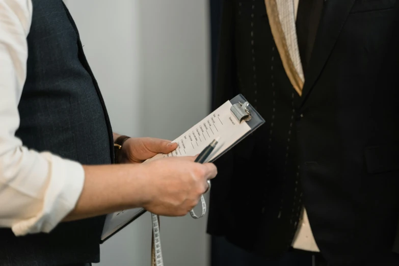 a couple of men standing next to each other, pexels contest winner, private press, holding a clipboard, intricate suit, measurements, thumbnail