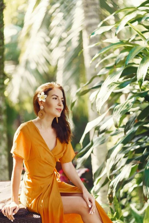 a woman in an orange dress sitting on a rock, trending on pexels, tropical foliage, plumeria, avatar image, joanna gaines