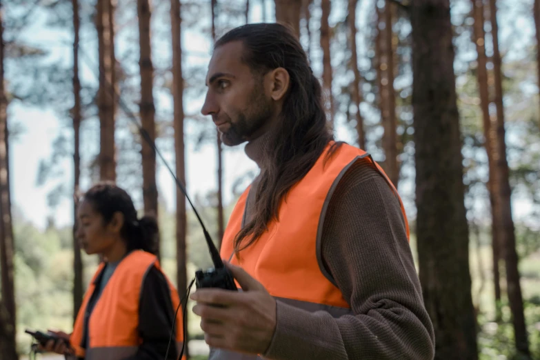 a couple of men standing next to each other in a forest, by Anato Finnstark, hurufiyya, orange safety vest, avatar image, close-up photo, hunting