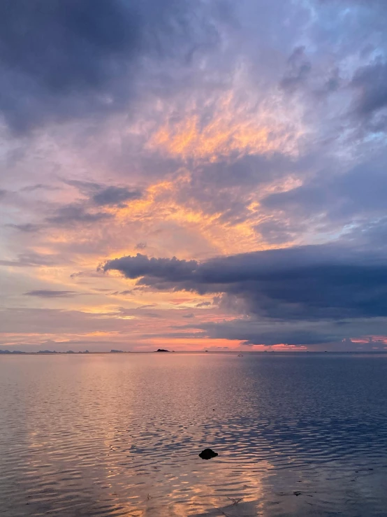 a large body of water under a cloudy sky, a picture, pexels contest winner, romanticism, colorful sunset!!, # nofilter, multiple stories, cindy avelino