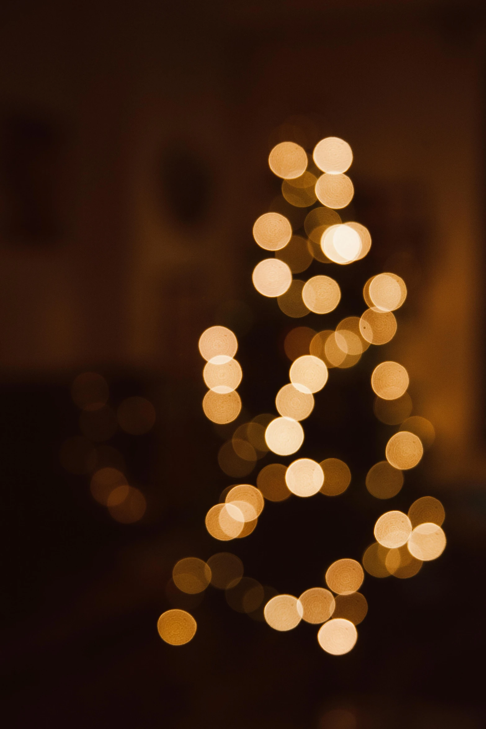 a lit christmas tree in a dark room, pexels, light and space, soft golden hour lighting, 4 5 mm bokeh, boke