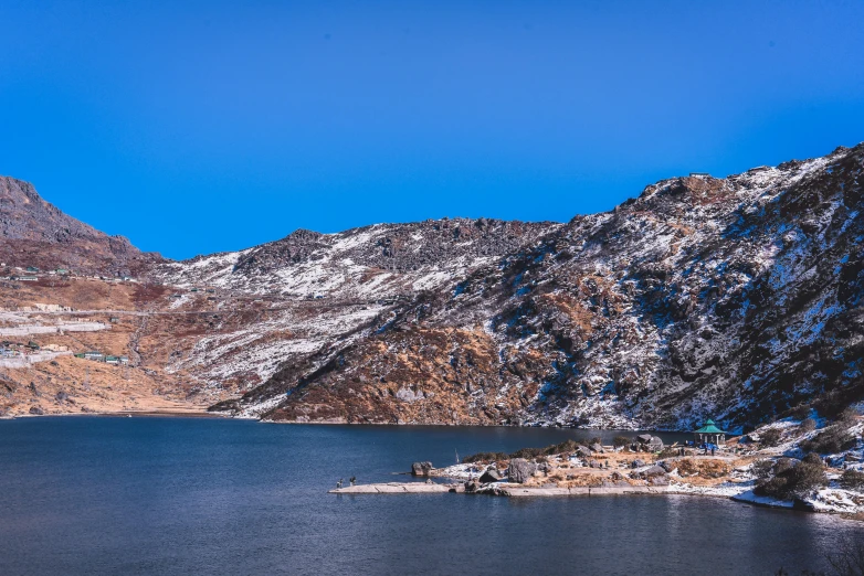 a body of water surrounded by snow covered mountains, fishing village, magical sparkling lake, slide show, naranbaatar ganbold