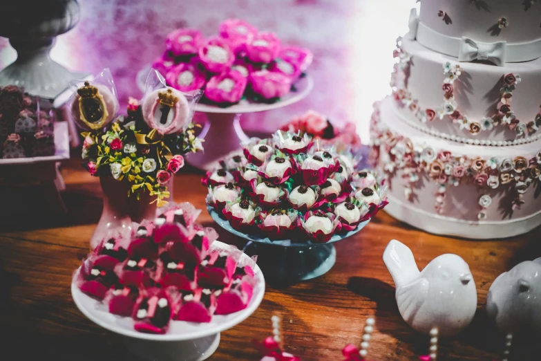 a table topped with lots of cakes and cupcakes, a cartoon, pexels, magenta colours, thumbnail, rustic, sweets