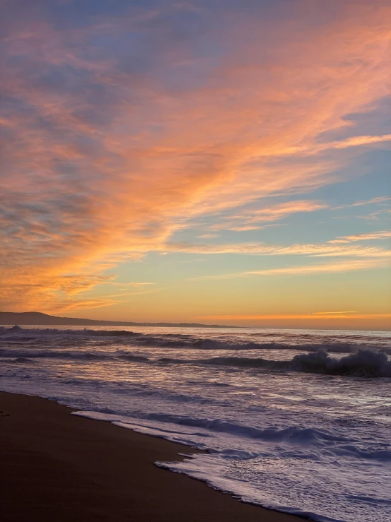 a large body of water sitting on top of a sandy beach, by Robbie Trevino, unsplash contest winner, golden hour in pismo california, colorful clouds, profile image, # nofilter