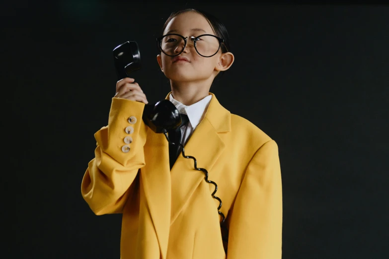 a woman in a yellow suit holding a phone to her ear, trending on pexels, neo-dada, school uniform, bella poarch, wearing robes and neckties, avatar image